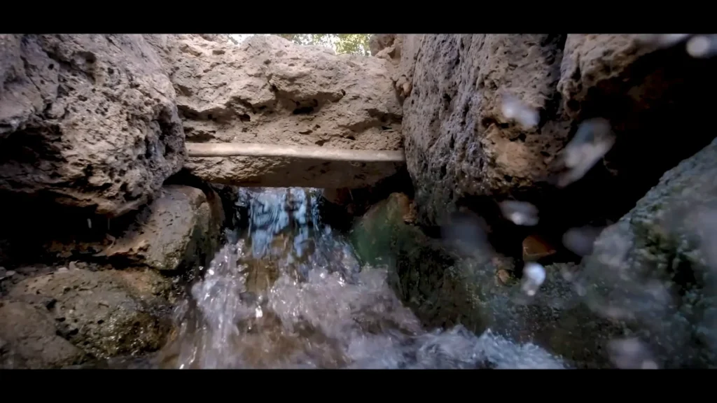 natural spring gushing from underground stone outlet near ancient madinah wells
