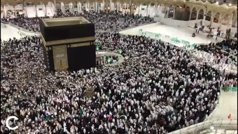 Muslim pilgrim in Ihram entering Masjid al-Haram for Tawaf al-Qudum at dawn