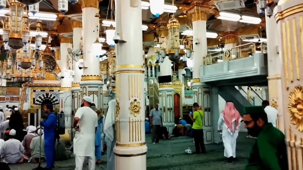 Worshipper praying in Riyadh ul Jannah with hands raised in dua near Prophet’s ﷺ Rawdah – emotional moment of spiritual connection and divine mercy